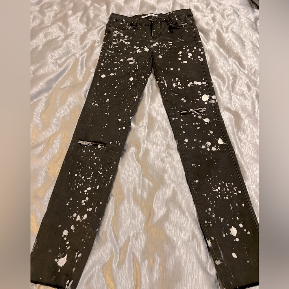 Distressed skinny black jeans with cream paint specs from Zara